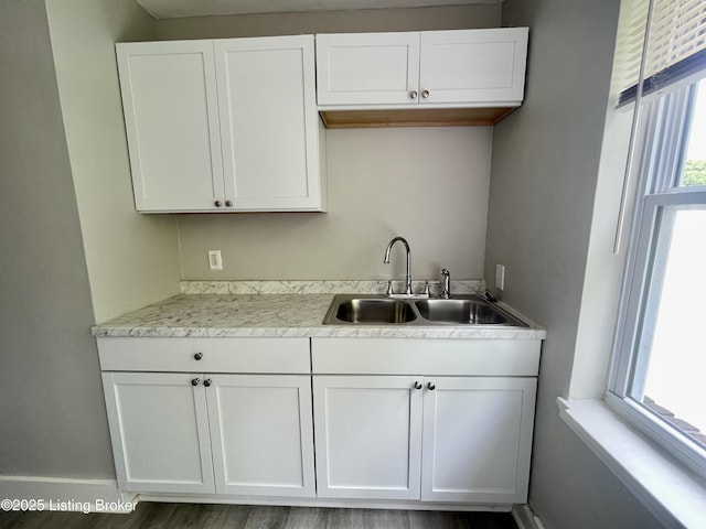 4143 Hillview Ave, Louisville, KY 40216 - kitchen with a sink, white cabinetry, light countertops, and baseboards