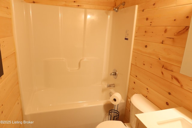 255 Little Cabin Ln, Falls Of Rough, KY 40119 - bathroom featuring toilet, shower / bathtub combination, wooden walls, and vanity