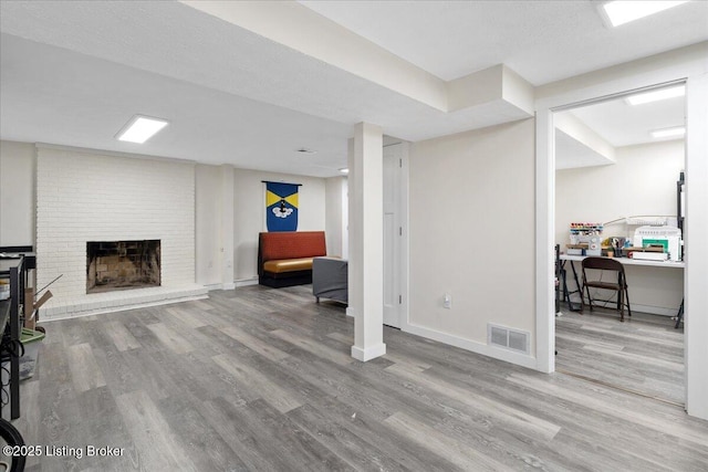 812 Castlewood Dr, New Albany, IN 47150 - finished below grade area featuring wood finished floors, baseboards, and a brick fireplace