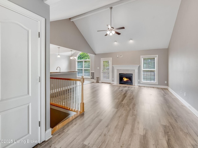 14409 Estate Ridge Blvd, Louisville, KY 40291 - unfurnished living room featuring a ceiling fan, beamed ceiling, wood finished floors, baseboards, and a premium fireplace