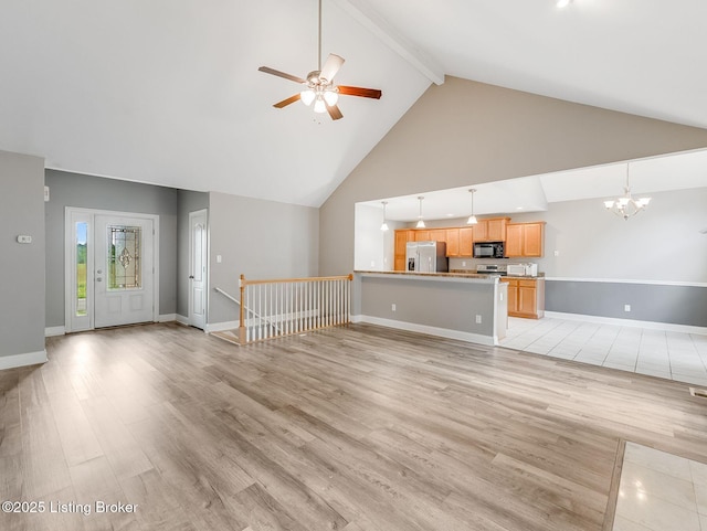 14409 Estate Ridge Blvd, Louisville, KY 40291 - unfurnished living room with beam ceiling, high vaulted ceiling, ceiling fan, light wood-type flooring, and a chandelier
