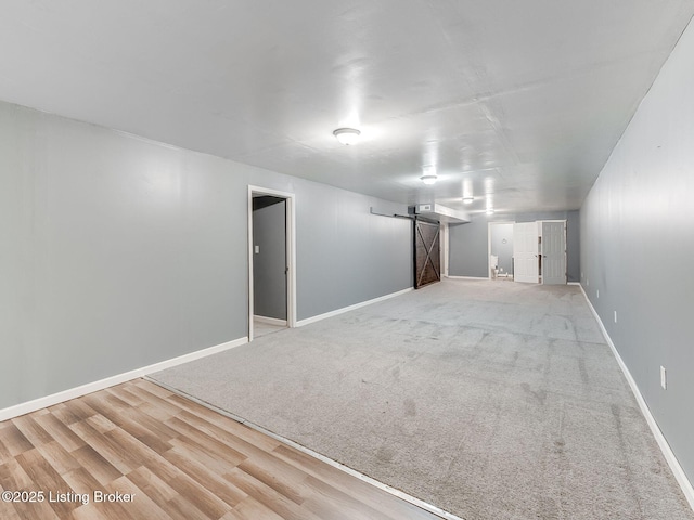 14409 Estate Ridge Blvd, Louisville, KY 40291 - finished basement featuring a barn door, baseboards, and wood finished floors