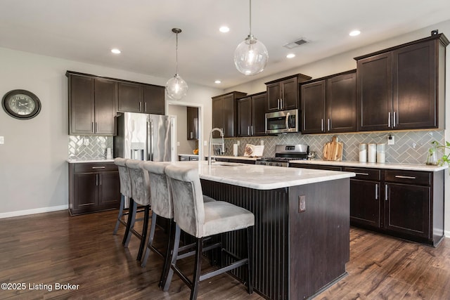 6803 Park Vista Way, Louisville, KY 40229 - kitchen featuring appliances with stainless steel finishes, a sink, decorative backsplash, dark brown cabinets, and dark wood-style flooring