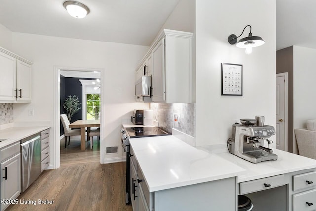 4705 Holly Forest Ct, Louisville, KY 40245 - kitchen with electric range, stainless steel dishwasher, dark wood finished floors, and tasteful backsplash