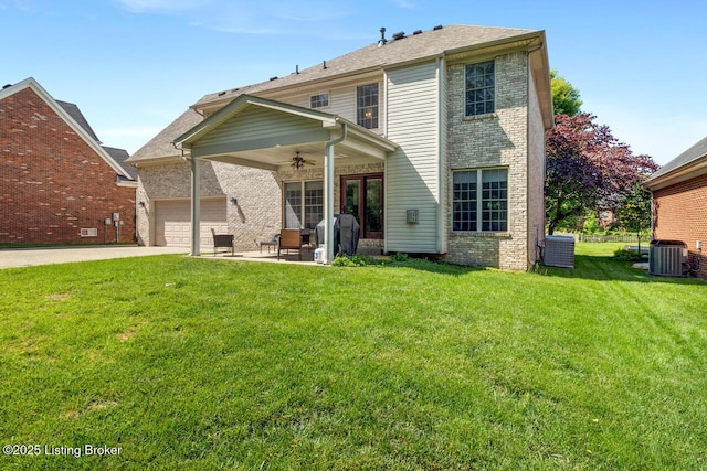 4705 Holly Forest Ct, Louisville, KY 40245 - back of property featuring brick siding, a ceiling fan, a lawn, concrete driveway, and central air condition unit
