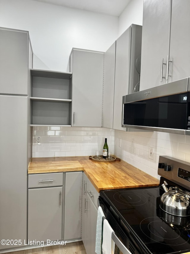 445 Marret Ave, Louisville, KY 40208 - kitchen with appliances with stainless steel finishes, gray cabinets, butcher block counters, open shelves, and tasteful backsplash