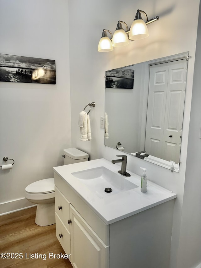 445 Marret Ave, Louisville, KY 40208 - bathroom with wood finished floors, vanity, toilet, and baseboards