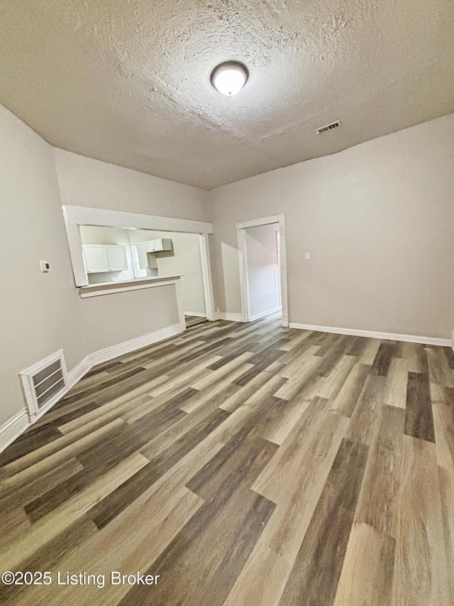 1724 Garland Ave, Louisville, KY 40210 - unfurnished room featuring a textured ceiling, wood finished floors, and baseboards