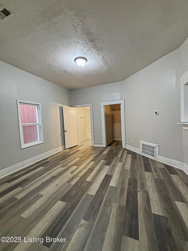 1724 Garland Ave, Louisville, KY 40210 - unfurnished bedroom with wood finished floors, a textured ceiling, and baseboards