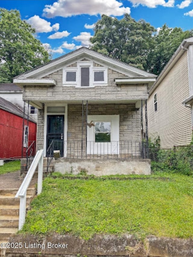 1724 Garland Ave, Louisville, KY 40210 - view of front facade featuring stone siding, a porch, and a front lawn