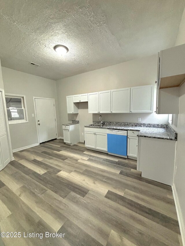 1724 Garland Ave, Louisville, KY 40210 - kitchen with dishwasher, white cabinetry, a textured ceiling, wood finished floors, and baseboards