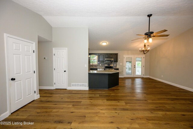 198 Cecilia Smiths Mill Rd, Cecilia, KY 42724 - kitchen featuring stainless steel appliances, lofted ceiling, light countertops, baseboards, and dark wood-style floors