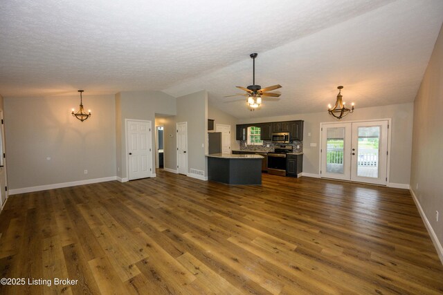 198 Cecilia Smiths Mill Rd, Cecilia, KY 42724 - unfurnished living room featuring a chandelier, dark wood-style flooring, a ceiling fan, lofted ceiling, and baseboards