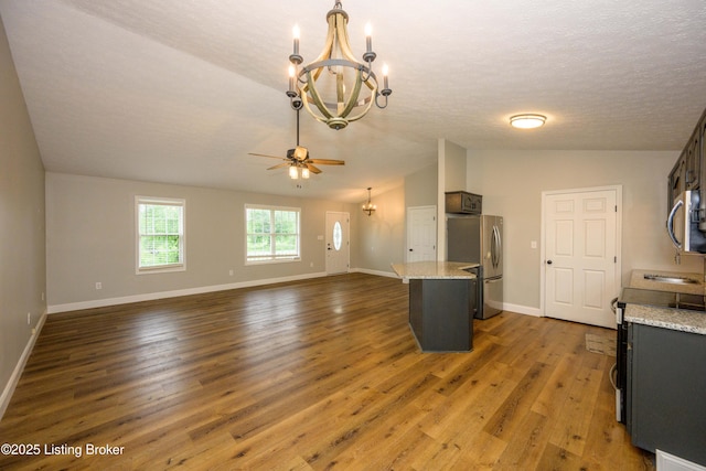 198 Cecilia Smiths Mill Rd, Cecilia, KY 42724 - kitchen featuring appliances with stainless steel finishes, a chandelier, lofted ceiling, wood finished floors, and a ceiling fan