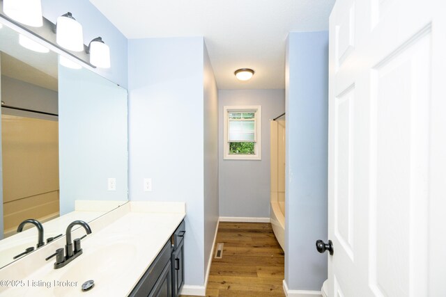 198 Cecilia Smiths Mill Rd, Cecilia, KY 42724 - bathroom featuring vanity, wood finished floors, shower / bath combo with shower curtain, and baseboards