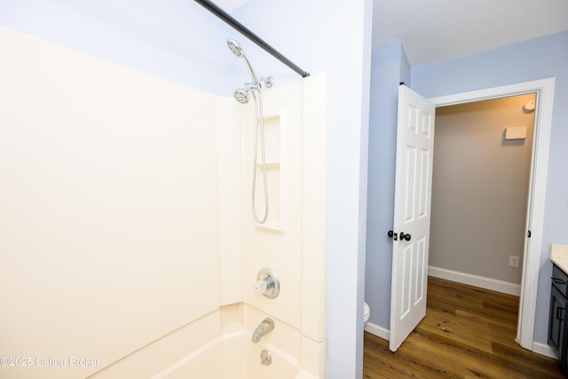 198 Cecilia Smiths Mill Rd, Cecilia, KY 42724 - bathroom with vanity, wood finished floors, bathtub / shower combination, toilet, and baseboards