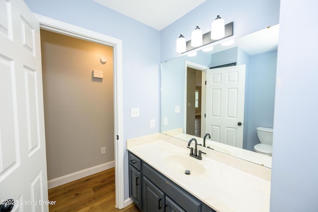 198 Cecilia Smiths Mill Rd, Cecilia, KY 42724 - bathroom featuring wood finished floors, vanity, toilet, and baseboards