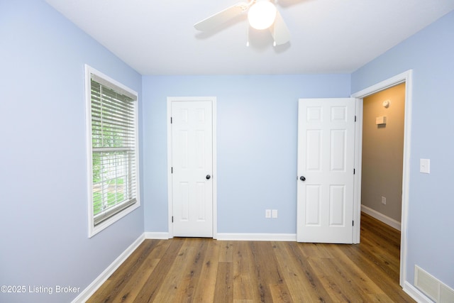 198 Cecilia Smiths Mill Rd, Cecilia, KY 42724 - unfurnished bedroom featuring wood finished floors, baseboards, ceiling fan, and a closet