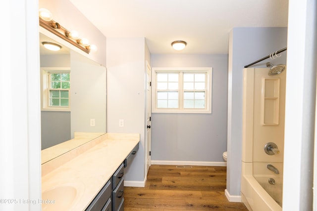 198 Cecilia Smiths Mill Rd, Cecilia, KY 42724 - full bath with vanity, wood finished floors, toilet, baseboards, and  shower combination