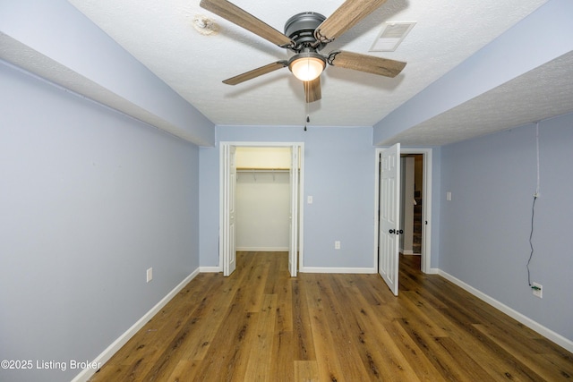 198 Cecilia Smiths Mill Rd, Cecilia, KY 42724 - unfurnished bedroom with wood finished floors, baseboards, ceiling fan, and a closet