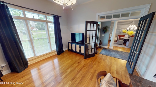 103 Morgan Ct, Bardstown, KY 40004 - living area with a chandelier, light wood finished floors, french doors, and baseboards
