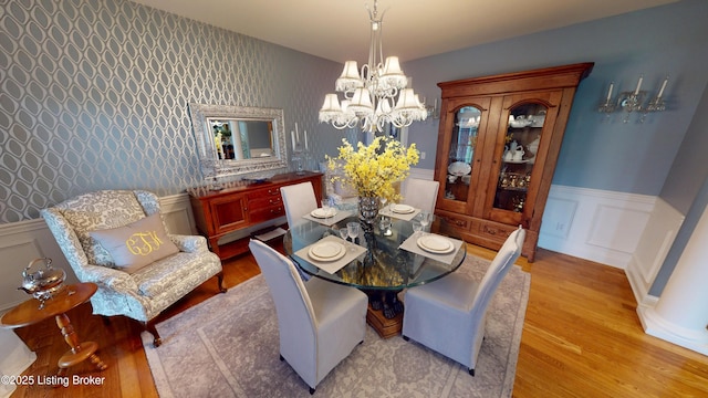 103 Morgan Ct, Bardstown, KY 40004 - dining area with wood finished floors, a chandelier, wainscoting, wallpapered walls, and a decorative wall