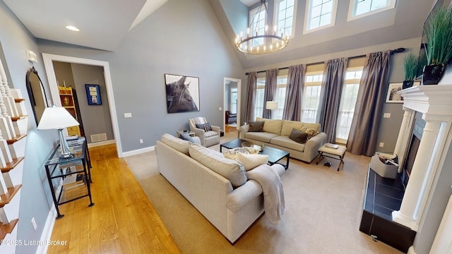 103 Morgan Ct, Bardstown, KY 40004 - living room with light wood-type flooring, a chandelier, high vaulted ceiling, baseboards, and a fireplace with raised hearth