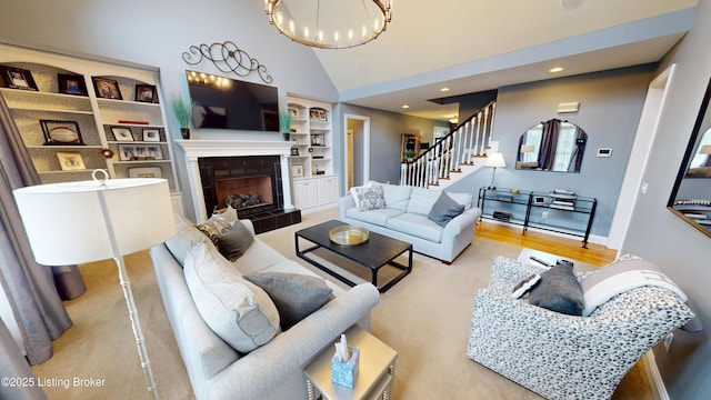 103 Morgan Ct, Bardstown, KY 40004 - living room featuring stairs, built in features, a tile fireplace, a chandelier, and high vaulted ceiling