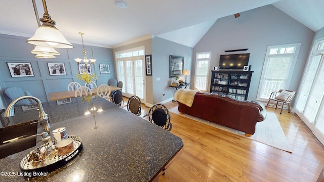 103 Morgan Ct, Bardstown, KY 40004 - dining space with light wood-type flooring, plenty of natural light, a chandelier, crown molding, and vaulted ceiling