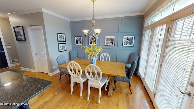 103 Morgan Ct, Bardstown, KY 40004 - dining room with a chandelier, ornamental molding, light wood finished floors, a decorative wall, and baseboards