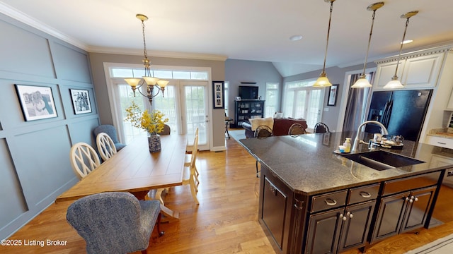 103 Morgan Ct, Bardstown, KY 40004 - kitchen featuring black fridge, a sink, dark brown cabinets, an island with sink, and ornamental molding