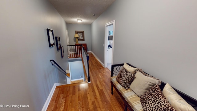 103 Morgan Ct, Bardstown, KY 40004 - hall with an upstairs landing, wood finished floors, baseboards, and a textured ceiling