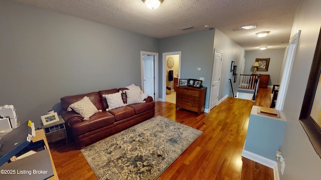 103 Morgan Ct, Bardstown, KY 40004 - living room featuring wood finished floors, a textured ceiling, and baseboards