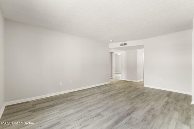 623 Westport Rd, Elizabethtown, KY 42701 - spare room with wood finished floors, a textured ceiling, and baseboards