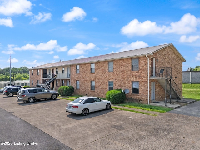 623 Westport Rd, Elizabethtown, KY 42701 - view of building exterior with stairway and uncovered parking