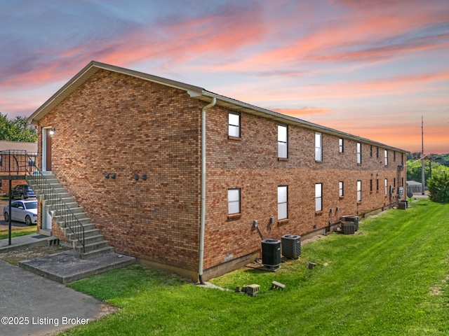623 Westport Rd, Elizabethtown, KY 42701 - view of side of home with central AC unit, stairway, a yard, and brick siding
