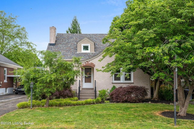 857 Melford Ave, Louisville, KY 40217 - cape cod house featuring a chimney, a front lawn, and brick siding