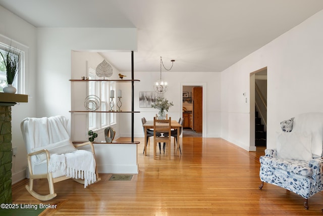 857 Melford Ave, Louisville, KY 40217 - dining room featuring a chandelier, light wood finished floors, and baseboards