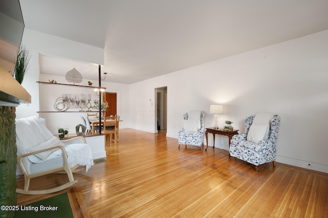 857 Melford Ave, Louisville, KY 40217 - living area with wood finished floors, baseboards, and a chandelier