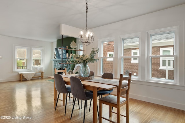 857 Melford Ave, Louisville, KY 40217 - dining room with light wood-style flooring, baseboards, and a chandelier