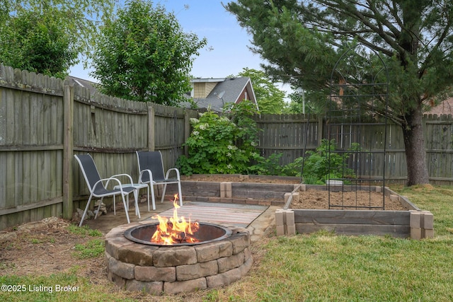 857 Melford Ave, Louisville, KY 40217 - fenced backyard with an outdoor fire pit and a garden