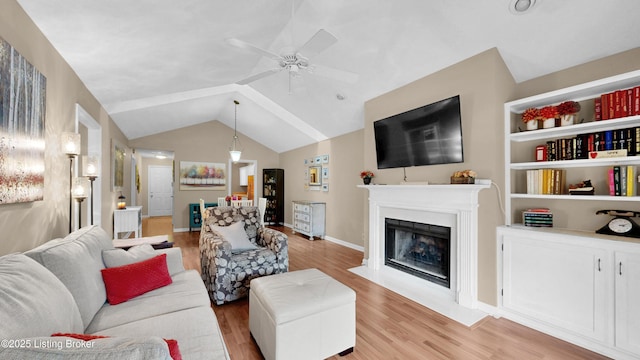 208 Forest Park Rd, Louisville, KY 40223 - living room featuring light wood-type flooring, a ceiling fan, a fireplace with flush hearth, vaulted ceiling, and baseboards