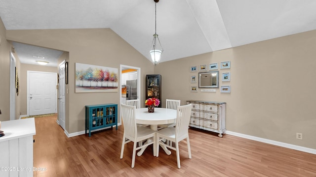 208 Forest Park Rd, Louisville, KY 40223 - dining space with baseboards, light wood-style floors, and vaulted ceiling