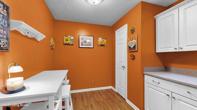 208 Forest Park Rd, Louisville, KY 40223 - office area with light wood-type flooring, a textured ceiling, and baseboards