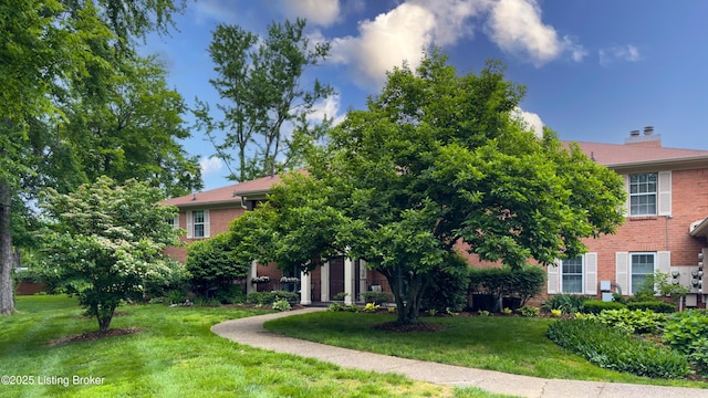 208 Forest Park Rd, Louisville, KY 40223 - view of front facade with brick siding, a front yard, and a chimney