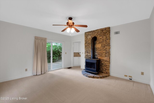 5212 Mary Clayton Ln, Crestwood, KY 40014 - unfurnished living room featuring a wood stove, carpet, and ceiling fan