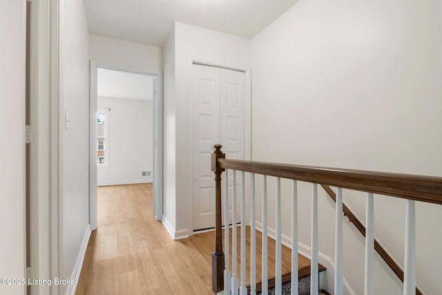 1932 Manor House Dr, Louisville, KY 40220 - corridor with light wood-type flooring, an upstairs landing, and baseboards