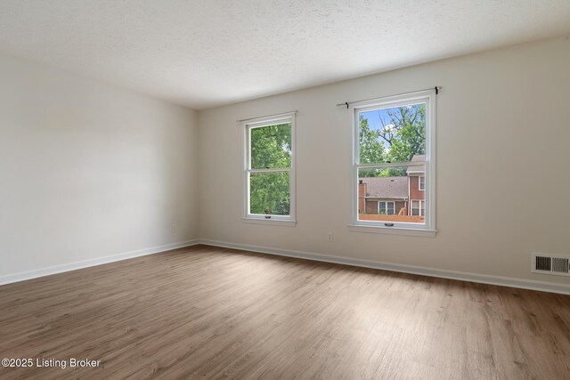 1932 Manor House Dr, Louisville, KY 40220 - empty room featuring wood finished floors, baseboards, and a textured ceiling