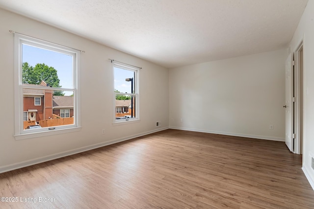 1932 Manor House Dr, Louisville, KY 40220 - unfurnished room featuring light wood-style flooring, baseboards, and a textured ceiling
