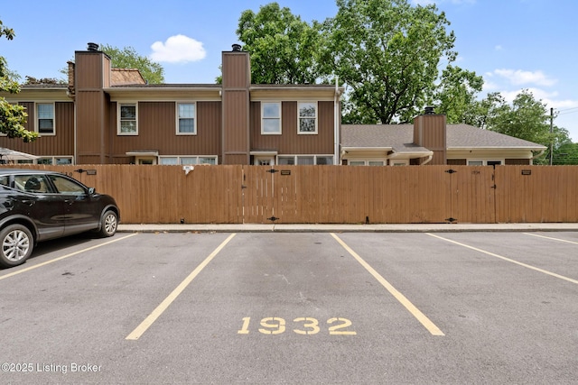1932 Manor House Dr, Louisville, KY 40220 - uncovered parking lot featuring a gate